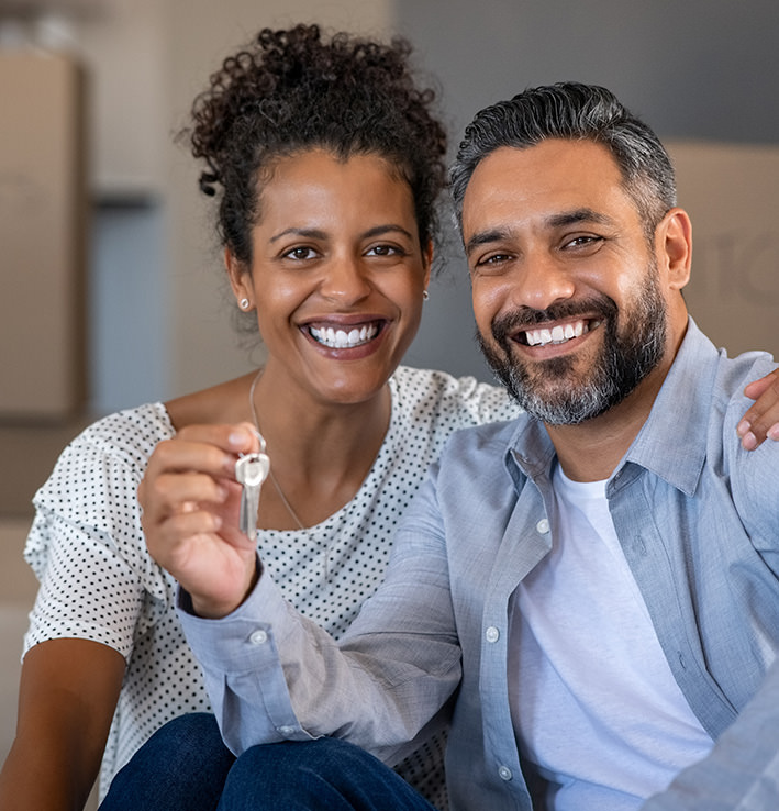 Husband and wife image with keys to new home image