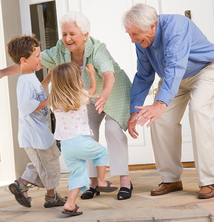 Happy grandparents hugging grandchildren image